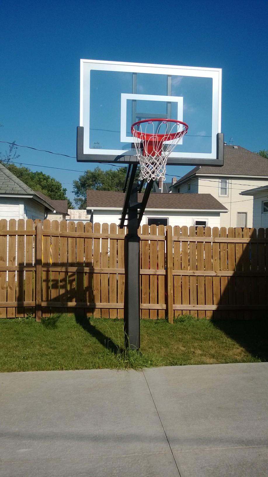 The Pro Dunk Silver basketball system is centered on the expansion joint of this backyard basketball court.