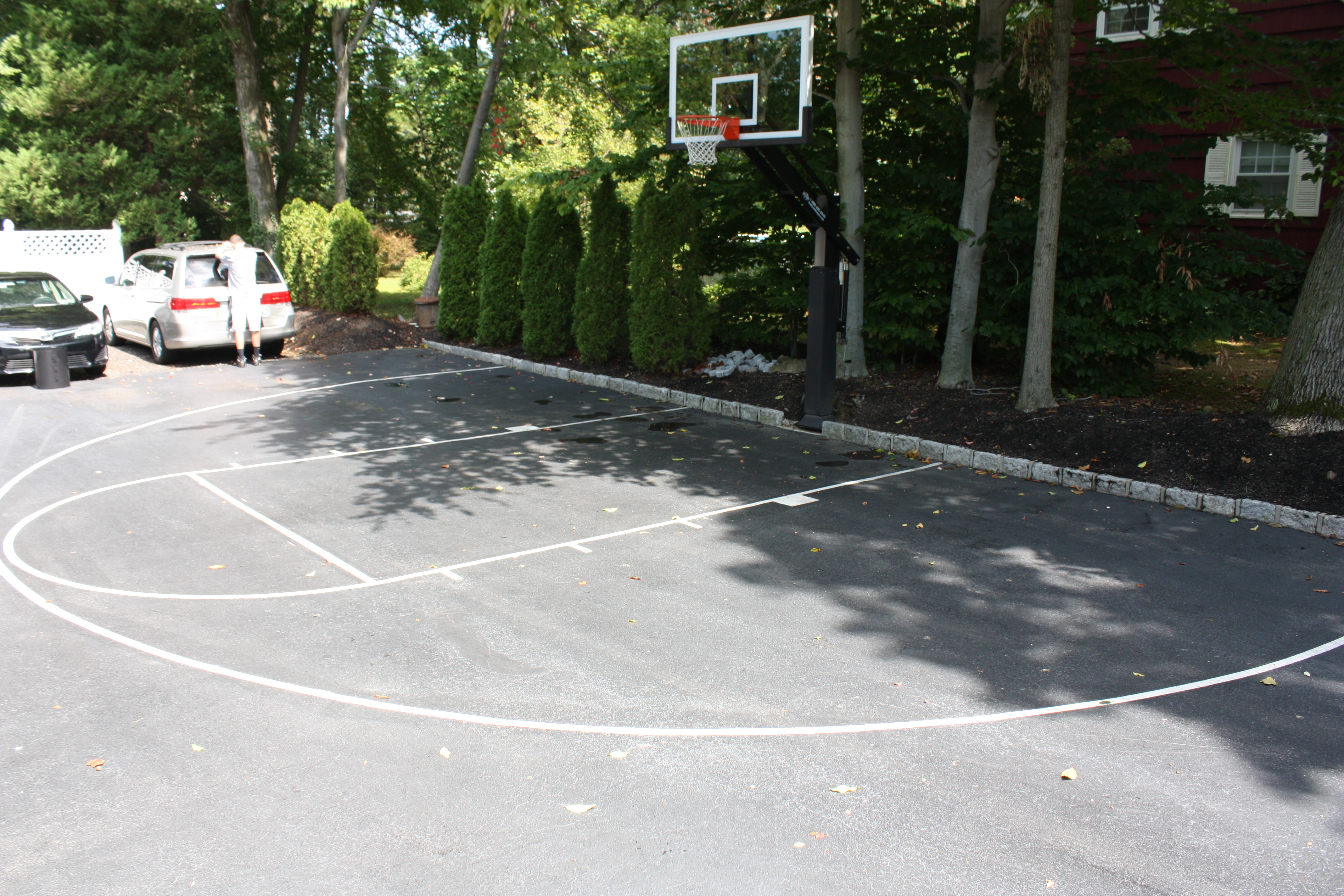 Well done on the striping of this court.  The white is a good contrast to the black asphalt and everything has been done including the key, jump circle and three-point line.