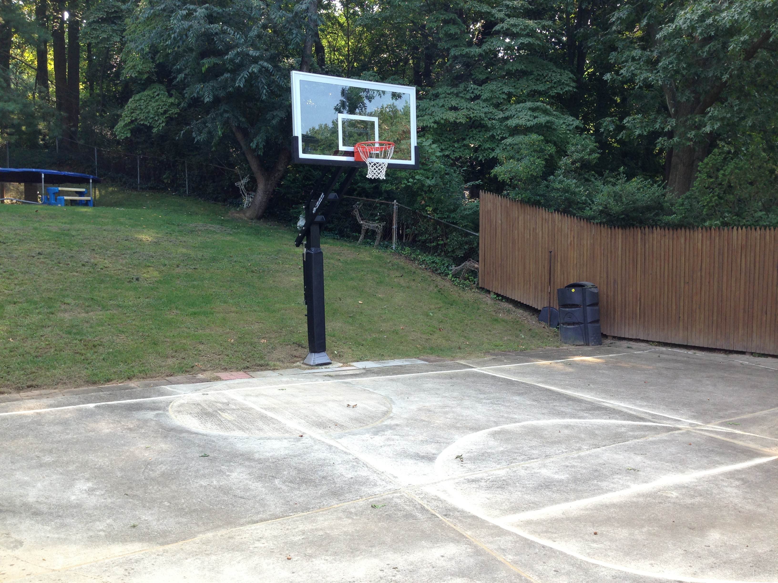Backyard hardscape doubles as a basketball court.