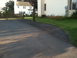 There is a closer look at the expanded asphalt concrete driveway around the system.