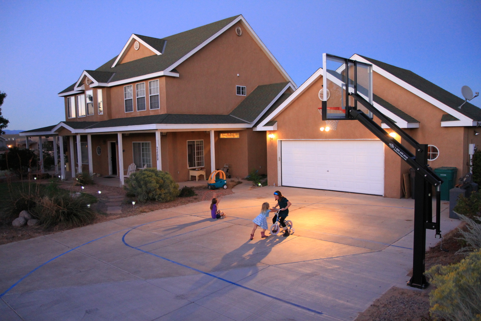 Standing tall in front of a picturesque home, this Pro Dunk Platinum Basketball system is a great addition to the property.