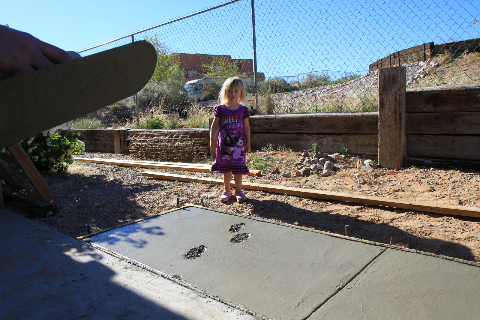 This little one leaves her mark on the fresh concrete poured for this Pro Dunk Platinum Basketball system installation. 