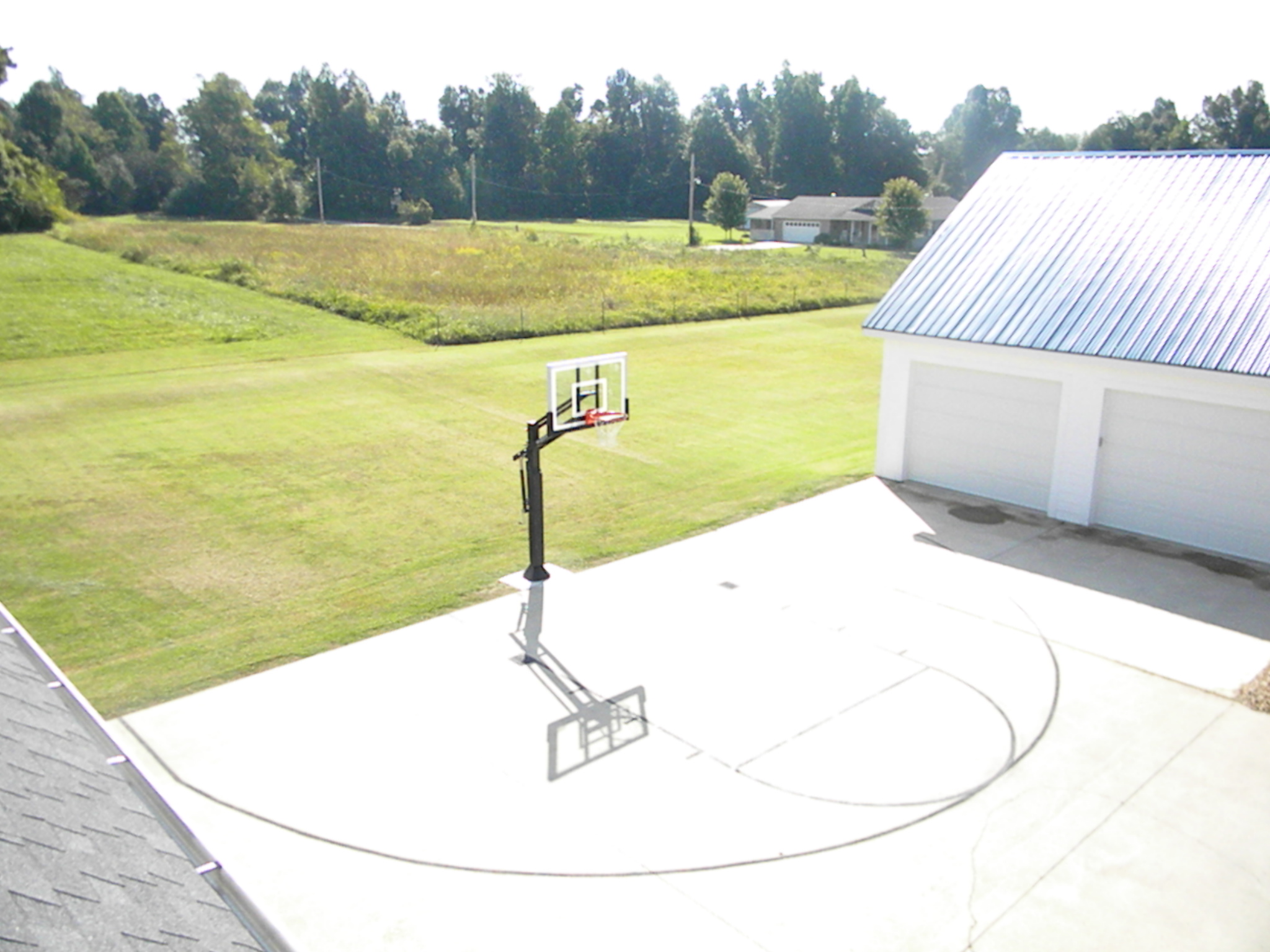 This top down view shows a Pro Dunk Silver Basketball installed above a concrete driveway.