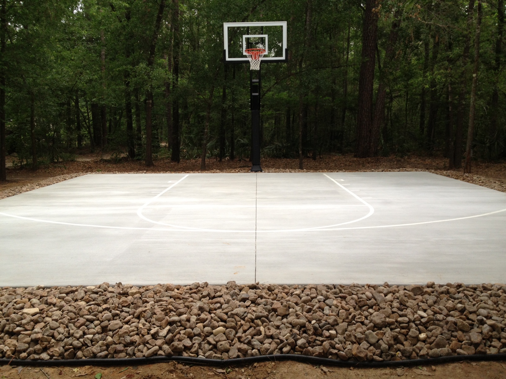 A nicely striped half court is the finishing touch in this backyard. 
