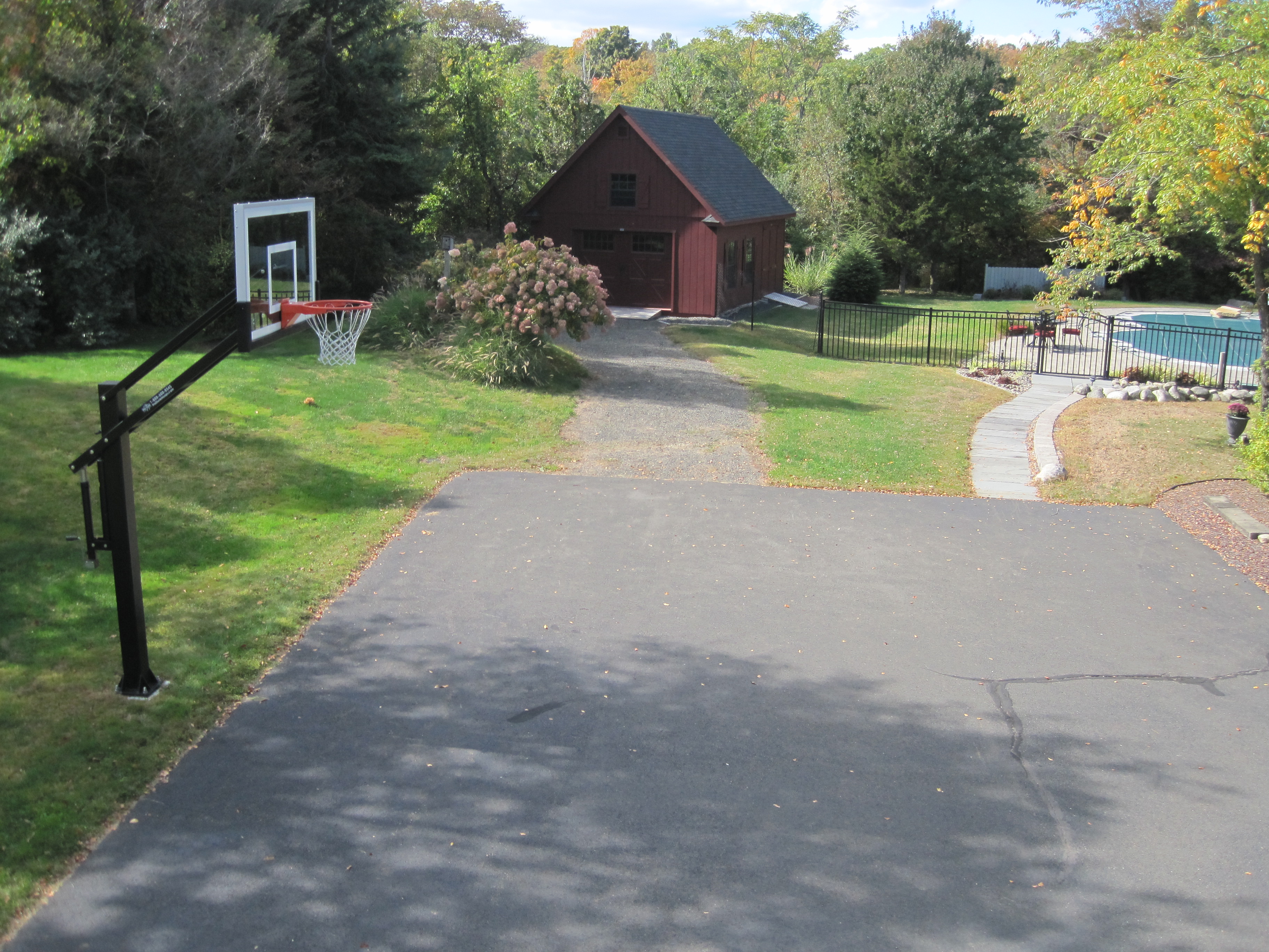 This loft view shows the Pro Dunk Gold Basketball system installed next to this Connecticut home's driveway.