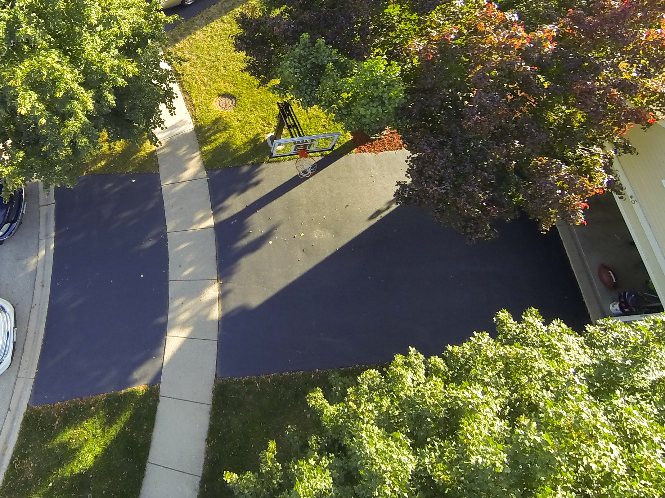 Aerial view of Pro Dunk Gold Basketball and better view of the asphalt driveway as great playing area. 